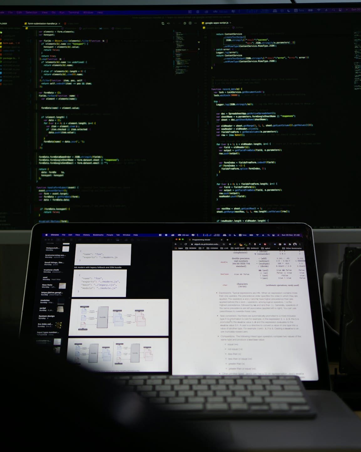 Two computer monitors display lines of code on a desk.